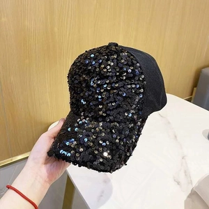 Detail view of shimmering black sequins on the visor and breathable mesh of the baseball cap