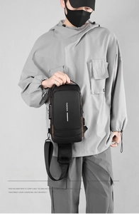 Detail of waterproof crossbody bag featuring a side USB port and anti-theft security lock