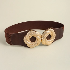Detail of a brown elastic waist belt featuring a luxury interlocking gold ring metal buckle