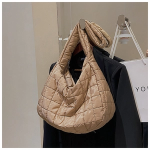 Detail of beige quilted nylon hobo bag featuring large capacity and soft texture