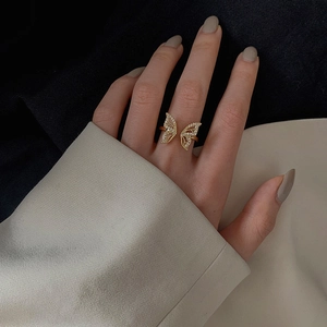 Elegant gold butterfly open ring with sparkling cubic zirconia on a model's finger