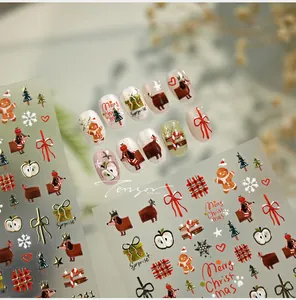 Detailed view of Christmas nail stickers featuring gingerbread men and dachshunds