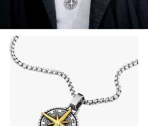 Detailed close-up of a silver compass pendant with gold accents on a box chain
