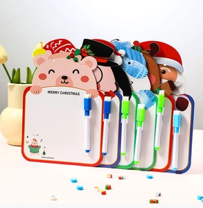 Close-up of Christmas magnetic whiteboards with Santa and Reindeer cartoons and markers