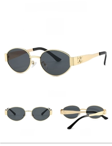 Detailed close-up of retro oval metal frame sunglasses with decorative cut-out logo on temple