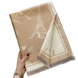 Beige faux cashmere scarf with Eiffel Tower pattern and heart details in a folded view