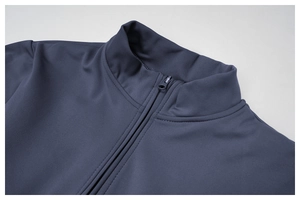 Close-up of the deep blue half-zip collar with precise stitching and elastic knit fabric