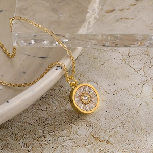 18K gold plated necklace with evil eye palm pendant and zircon inlays on an ice block