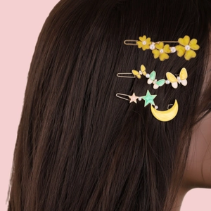 Elegant pearl hair clip set with butterfly, flower, and star moon designs on a model