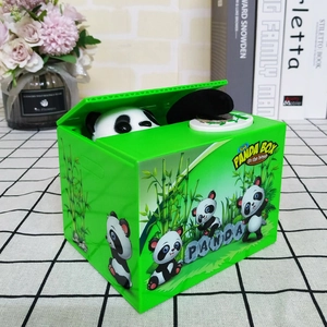 Detail of green electric panda money box picking up a coin on a checkered surface
