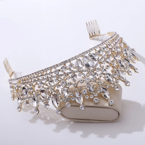 Close-up of gold bridal crown with crystal rhinestones and integrated hair combs