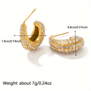 Detail view of gold C-shape conch earrings with rhinestones including size and weight specs