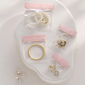 Pink EVA jewelry storage bags for anti-oxidation, showing rings and necklaces in 4-pack
