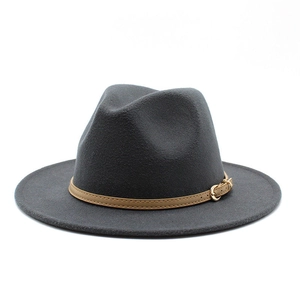 Close-up of a dark grey woolen jazz hat featuring a brown leather belt and gold buckle