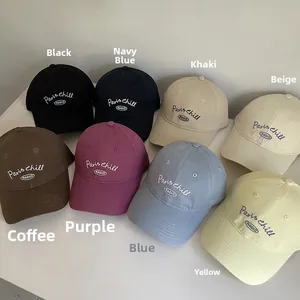 Flat lay of cotton baseball caps with Paris chill embroidery in eight different colors