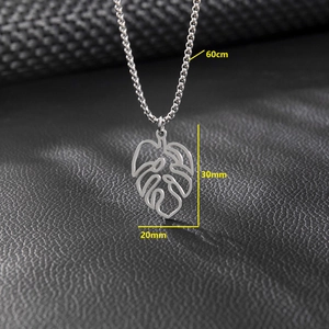Silver stainless steel palm leaf pendant necklace with dimensions on dark leather background