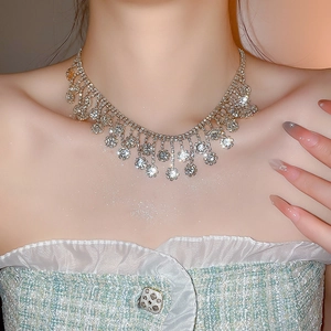 Close-up of sparkling silver zircon floral fringe necklace set on model neck