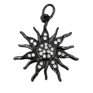 Macro shot of sun-shaped pendant with black plating and micro-pave white zircon details