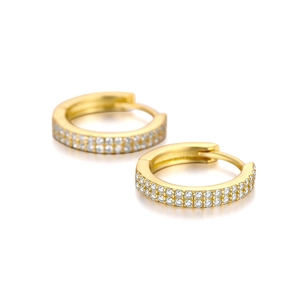 Close-up of gold curved earrings with double-row micro-pave cubic zirconia stones