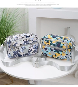 Detail view of water-resistant nylon crossbody bags in floral and camouflage patterns