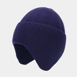 Close-up of dark blue ribbed knit hat showing warm earflaps and thick winter texture