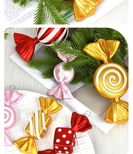 Close-up of candy-shaped Christmas tree ornaments with red and gold stripes and glitter