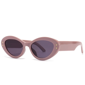 Modern baroque cat-eye sunglasses in dusty pink with wide temples and star accents