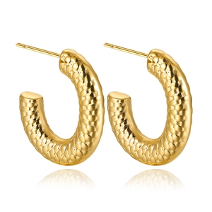Detail view of gold C-shaped hoop earrings with unique embossed snake scale texture
