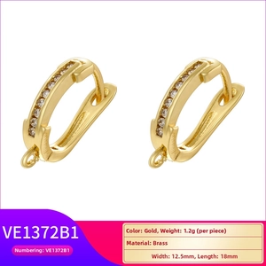 Detail of 18K gold-plated brass U-shaped earrings with zircons and 12.5x18mm dimensions