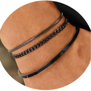 Three-piece set of black stainless steel jewelry featuring snake, Cuban, and cuff bracelets