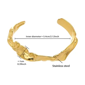 Detailed view of irregular lava texture gold stainless steel bangle measuring 5.4cm inner diameter