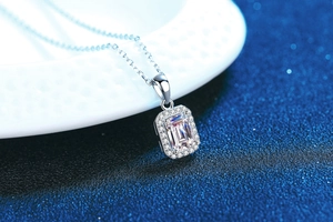 Macro shot of rectangular radiant cut moissanite pendant on a fine silver O-chain