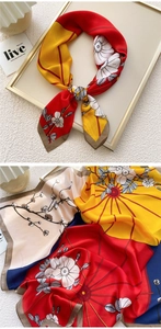 Detailed view of floral printed satin scarf with elegant red, blue and yellow patterns