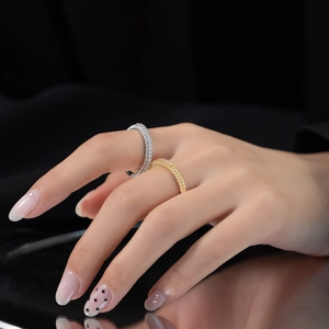 Close-up of elegant gold and silver rings with pave diamonds on model hand
