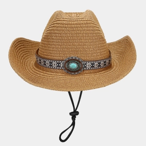 Detail of straw cowboy hat featuring ethnic pattern band and turquoise stone embellishment