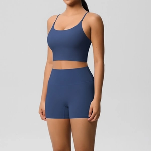 Detail of navy blue seamless yoga set showing high waist shorts and thin strap sports bra