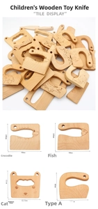 Detail of diverse animal-shaped beechwood toy knives with hanging holes for kids' play kitchen