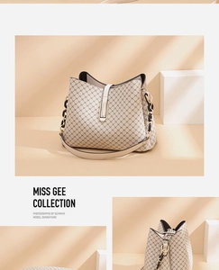 Detail of beige bucket bag with cross pattern print and elegant chain leather strap