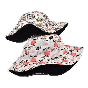 Reversible cotton bucket hat with colorful cow print and rainbow pattern for sun protection