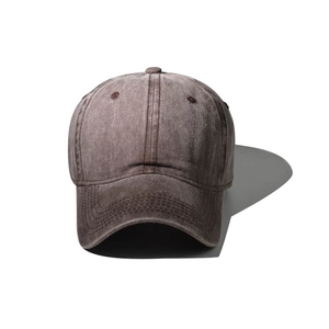 Detailed view of brown washed cotton baseball cap with vintage stitching and vent holes