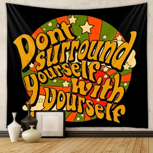Detail of bohemian rainbow tapestry with psychedelic circle pattern and vintage quote