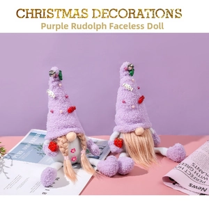 Close-up of purple Christmas gnomes set with knitted hats and golden bells