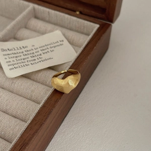 Minimalist matte gold heart-shaped open ring placed on a premium velvet jewelry box