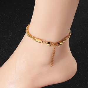 Close-up of golden stainless steel rope chain anklet with lobster clasp on ankle