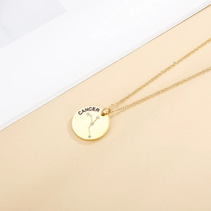 Macro detail of golden Cancer zodiac pendant with crystal studded constellation pattern