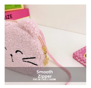 Detail of pink plush cat bag showing soft teddy fleece fabric and smooth gold zipper