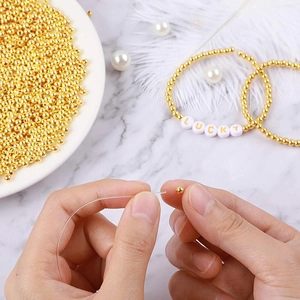 DIY jewelry kit with gold round beads and clear elastic cord for handmade bracelets