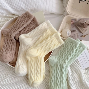Thick knit winter socks with cable pattern in brown, beige, and green tones