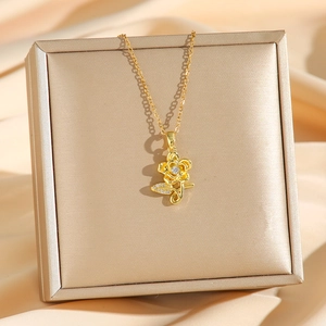 Exquisite gold rose pendant necklace with diamonds on elegant pink silk background