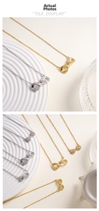Detailed macro view of infinity symbol necklaces in gold and silver with zircon accents